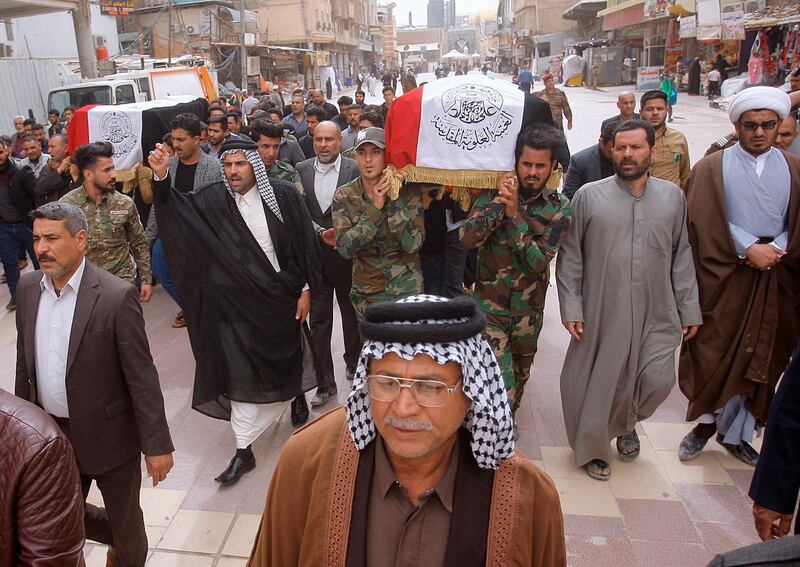Mourners and militia fighters chant slogans against the U.S.during the funeral procession of two fighters of the Popular Mobilization Forces who were killed during the US attack against militants in Iraq, during their funeral procession at the Imam Ali shrine in Najaf, Iraq. AP Photo