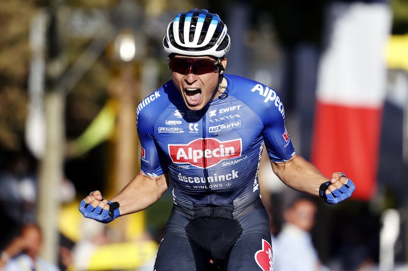 Alpecin Deceuninck rider Jasper Philipsen celebrates afterr winning Stage 21.