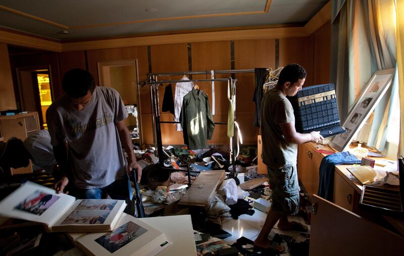 Rebel fighters search in the house of Aisha Gadhafi the daughter of Libyan dictator Moammar Gadhafi in Tripoli, LIbya, Wednesday, Aug. 24, 2011.  (AP Photo/Sergey Ponomarev) *** Local Caption ***  Mideast Libya.JPEG-0e073.jpg