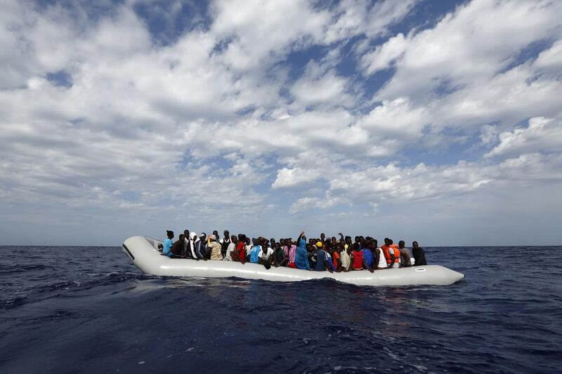 Illegal migrants onboard a rubber dinghy wait to be rescued by the Migrant Offshore Aid Station NGO about 40 kilometres off the Libyan coast. Moas via Reuters