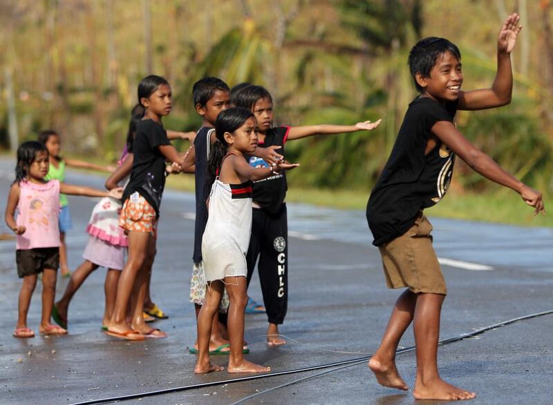 Filipino typhoon victim children beg on the streets of Marabut, Samar Island province following the devastating typhoon.  Francis Malasig/EPA