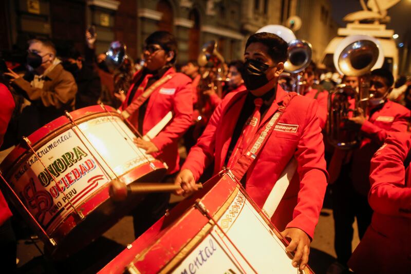 Members of a band play outside the headquarters of the "Free Peru" party after Peru's electoral authority announced Pedro Castillo as the winner of the presidential election, in Lima.