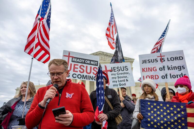 A pastor speaks at a small right-wing demonstration in support of the hundreds of people who were arrested and charged following the insurrection. Getty / AFP