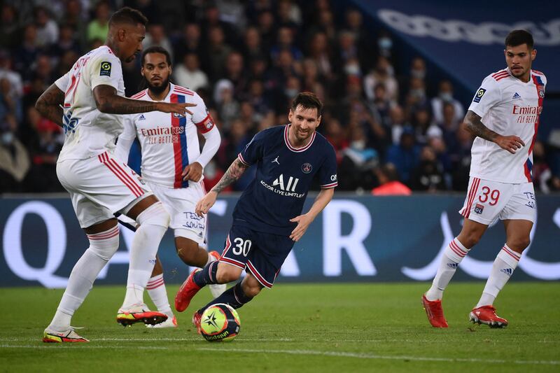 Paris Saint-Germain's Argentinian forward Lionel Messi challenges Lyon's German defender Jerome Boateng. AFP