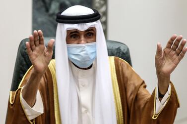 Sheikh Nawaf al-Ahmad Al-Sabah salutes the crowd after being sworn in as Kuwait's new Emir at the National Assembly in Kuwait City on September 30, 2020. Kuwait on Wednesday swore in its new emir, Sheikh Nawaf al-Ahmad Al-Sabah, after the death of his half-brother, Sheikh Sabah, who died in the US at the age of 91. / AFP / Yasser Al-Zayyat