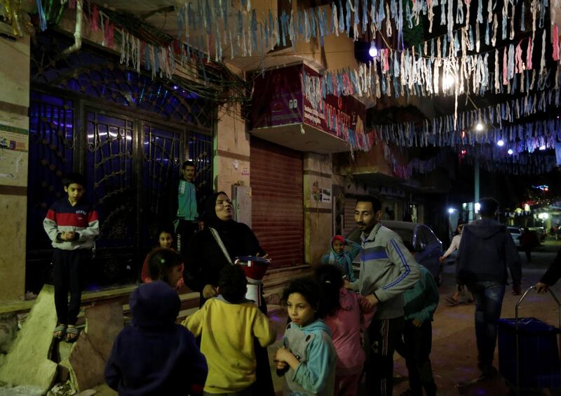 Hajja Dalal, a 46-year-old Mesaharati, beats a drum to wake up Muslims to have the predawn meal before they start their long-day fast during Ramadan, at Maadi neighbourhood in Cairo, Egypt. Reuters