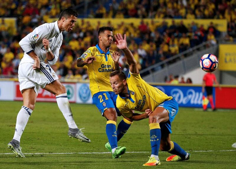 Real Madrid’s Cristiano Ronaldo and Las Palmas’ Jonathan Viera and Dani Castellano, right, in action. Juan Medina / Reuters