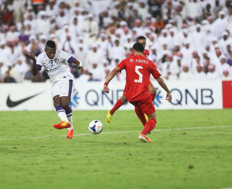 Asamoah Gyan, left, scores his first of two goals in the Asian Champions League game at Hazza bin Zayed Stadium on May 13 , 2014, to lift Al Ain over Al Jazira. Delores Johnson / The National

