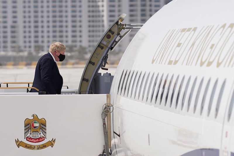 Boris Johnson boards his plane at Abu Dhabi airport after brief meetings with Emirati officials, as he heads to the Saudi capital Riyadh. Stefan Rousseau  /  AFP