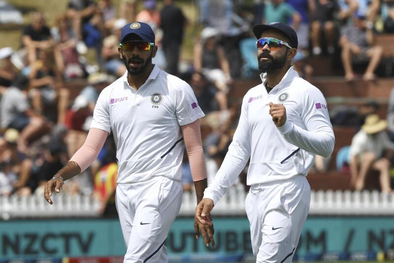 India's Jasprit Bumrah, left, and Virat Kohli head for lunch on the second day against New Zealand during the first cricket test between India and New Zealand at the Basin Reserve in Wellington, New Zealand, Saturday, Feb. 22, 2020. (AP Photo/Ross Setford)