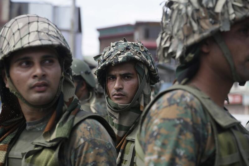 Paramilitary guard the site of a gun-battle in the Nowhatta neighborhood of Srinagar. Mukhtar Khan / AP Photo