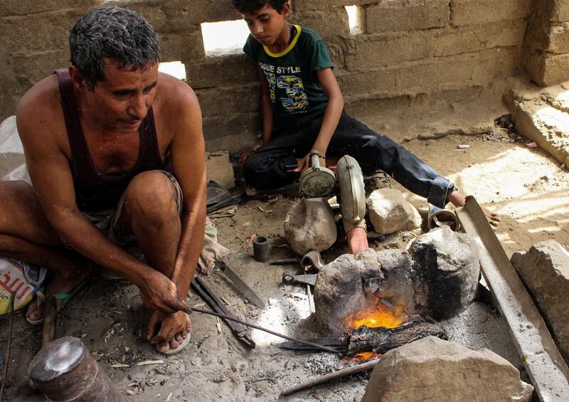 Yemenis burn wood to create a fire for the forge.