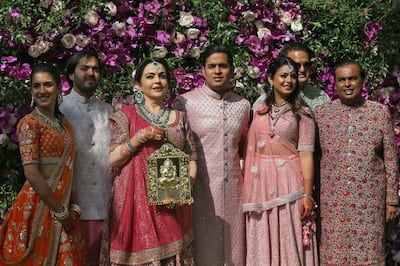 Radhika Merchant, left, with the Ambani family: Anant; Nita; Akash; Isha; Anand Piramal, Isha's husband; and Mukesh, at Akash's wedding in Mumbai in 2019. Reuters