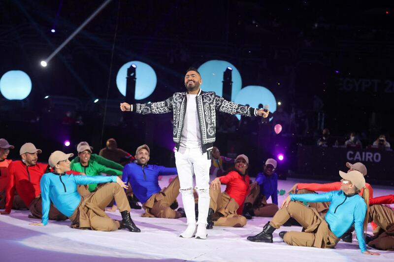 Egyptian singer Tamer Hosni (C) performs with dancers during the opening ceremony prior to the opening match of the 2021 World Men's Handball Championship between Group G teams Egypt and Chile at the Cairo Stadium Sports Hall in the Egyptian capital on January 13, 2021. (Photo by MOHAMED ABD EL GHANY / POOL / AFP)