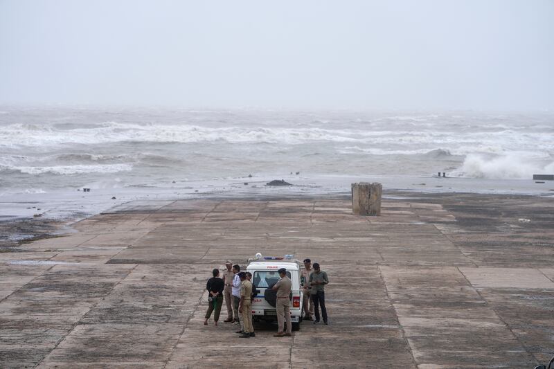 Policemen stand guard in Mandvi on the Arabian Sea coast ahead of Cyclone Biparjoy's landfall. AP