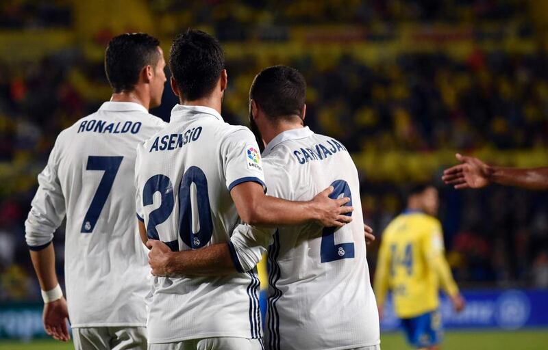 Real Madrid’s Cristiano Ronaldo, left, Marco Asensio, centre, and Daniel Carvajal celebrate. Desiree Martin / AFP