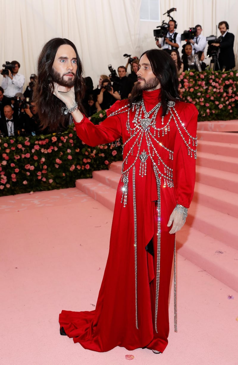 Wearing be-jewelled, floor lengt crimson, Jared Leto arrived carrying his own head. Reuters