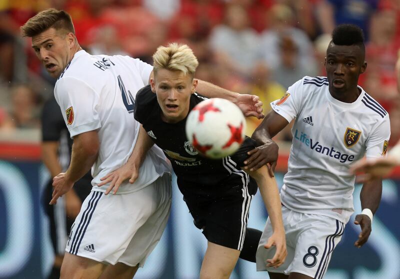 Manchester United's Scott McTominay, centre, in action with Real Salt Lake's Sunday Stephen and David Horst. Jim Urquhart / Reuters