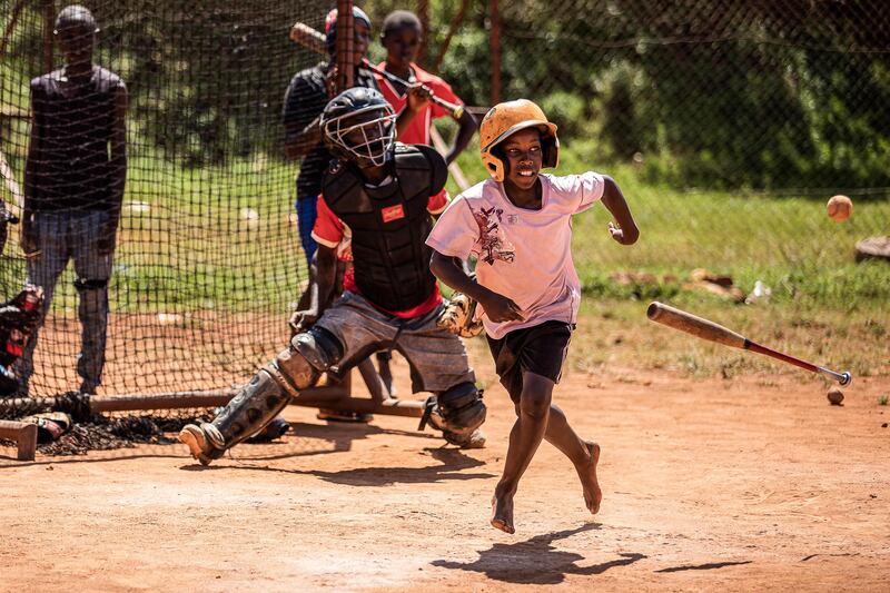 Dennis Kasumba (centre), 18, who dreams of becoming Uganda’s first US Major League Baseball player, takes part in a match in Gayaza, Uganda. AFP