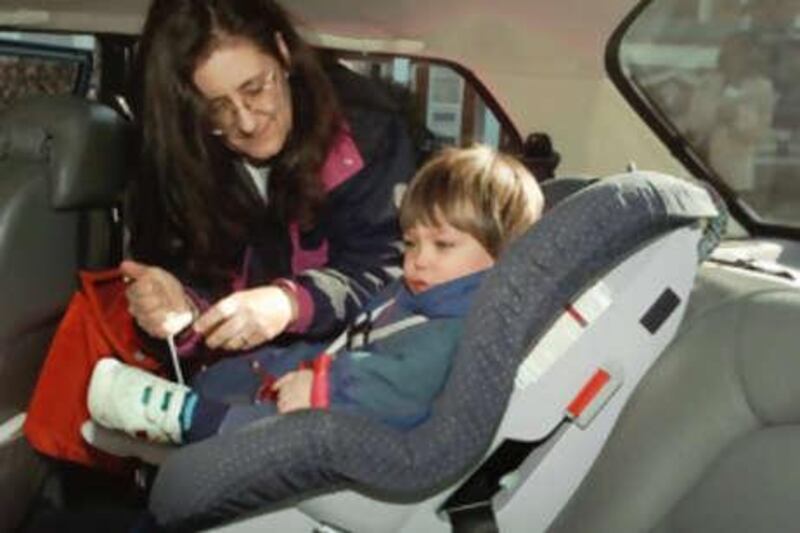 Susan Barocas, of Washington, buckles-up her one-and-a-half year-old son Samuel Phillips into his seat in the back of her car in Washington Tuesday Nov. 18,1997. Earlier Tuesday, the Transportation Department announced that people at high risk of injury or death from air bags could install an on-off switch for the devices. Some of those eligible for the device are motorists with car pool duties that require a child 12 or under to sit in the front seat. (AP Photo/J.Scott Applewhite)