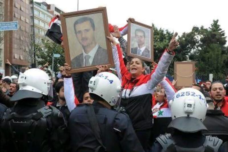 Syrians who support President Bashar Al Assad demonstrate outside the "Friends of Syria" meeting in Istanbul where foreign ministers from dozens of countries gathered to discuss the violence in Syria.