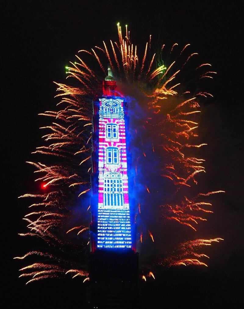 Fireworks and light effects illuminate the night sky from the Taipei 101 skyscraper during New Year's Eve celebrations in Taipei. Henry Lin / EPA
