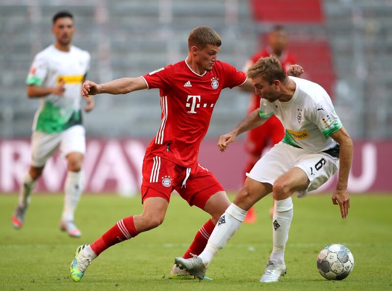 Bayern Munich's Mickael Cuisance is challenged by Christoph Kramer of Borussia Monchengladbach. EPA