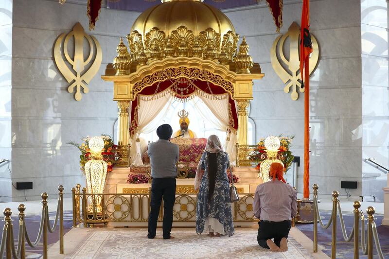 Dubai, United Arab Emirates - May 15, 2019: Members of the congregation pray. People take part in a multi faith Iftar at Gurunanak Darbar Sikh Gurudwara. Wednesday the 15th of May 2019. Jebel Ali, Dubai. Chris Whiteoak / The National