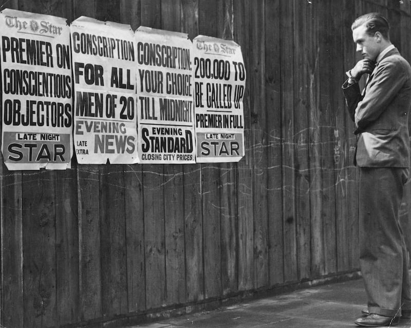 A man studying newspaper notices about conscription in 1939 at the outbreak of World War II
