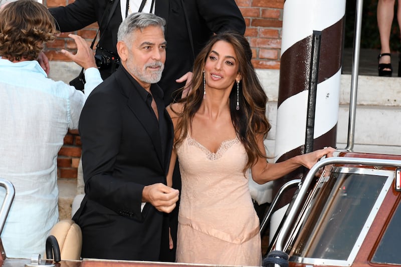George and Amal Clooney, wearing vintage Dior. Getty Images