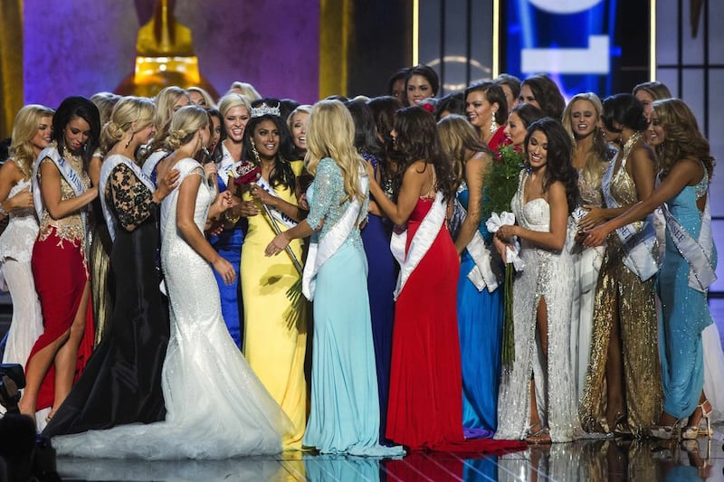 Miss America contestant, Miss New York Nina Davuluri (in yellow) celebrates with other contestants after being chosen winner of the 2014 Miss America Pageant. Reuters/Lucas Jackson