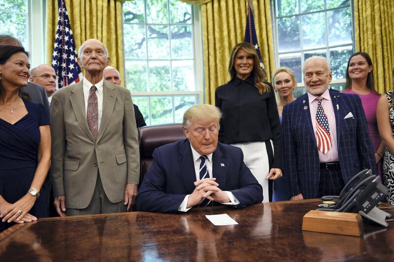 US President Donald Trump an First Lady Melania Trump host Apollo 11 crew members Michael Collins (L), Buzz Aldrin and their families  on July 19, 2019, at the White House in Washington, DC, during a ceremony commemorating the 50th anniversary of the Moon landing. (Photo by Brendan Smialowski / AFP)
