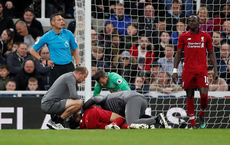 Salah receives medical attention after sustaining an injury. Lee Smith / Reuters