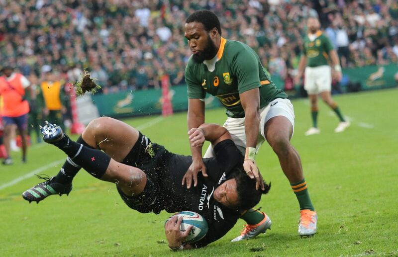 Caleb Clarke of New Zealand is tackled by South Africa's Lukhanyo Am. EPA