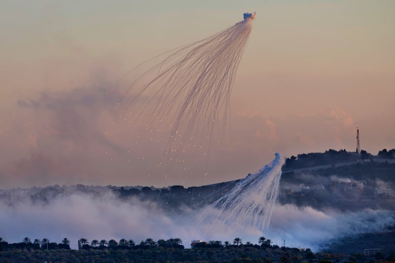 Israeli shells that appear to be white phosphorus explode over Dahaira, a Lebanese border village on October 16. AP