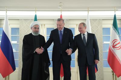 epa07846980 A handout picture provided by Turkish Presidential press office shows Turkish President Recep Tayyip Erdogan (C), Russian President Vladimir Putin (R) and Iranian President Hassan Rouhani (L) pose during a family photo session before their summit in Ankara, Turkey, 16 September 2019. Erdogan, Putin and Rouhani are in Ankara for a trilateral meeting for Syria talks.  EPA/MURAT CETINMUHURDAR/TURKISH PRESIDENTIAL PRESS OFFICE HANDOUT  HANDOUT EDITORIAL USE ONLY/NO SALES