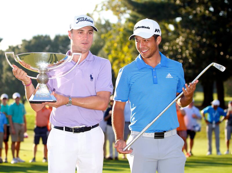 Sep 24, 2017; Atlanta, GA, USA; Justin Thomas hoists the trophy after winning the FedEx Cup with Xander Schauffele holding Calamity Jane a replica of Bobby Jones putter after winning the Tour Championship golf tournament at East Lake Golf Club. Mandatory Credit: Butch Dill-USA TODAY Sports