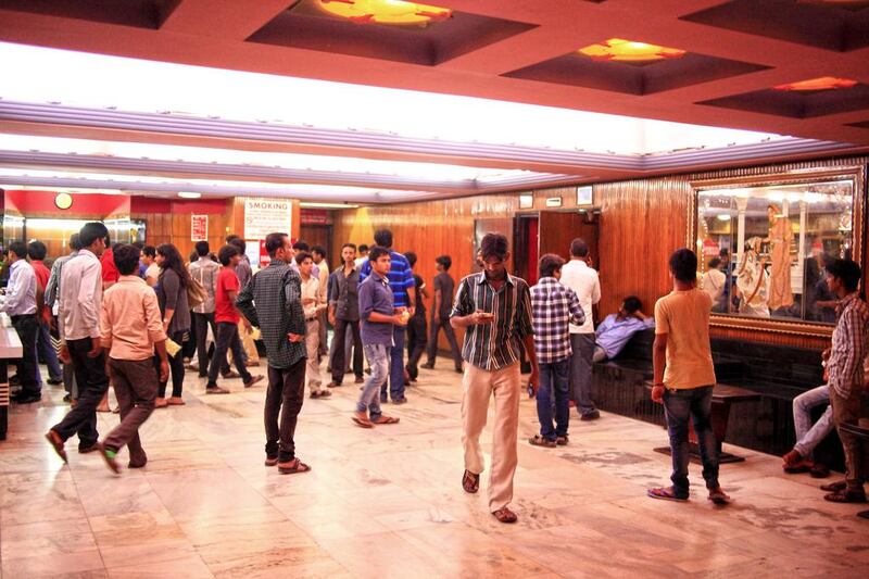 Cinema goers wait for the film to start at Maratha Mandir. Subhash Sharma for The National