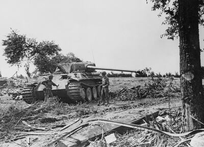 Captain Henry Baushausen and Lieutenant Gardner Colson of the 359th Infantry Regiment, 90th Infantry Division, United States Third Army examine a knocked Panzerkampfwagen V Aus G Panther tank from the 33rd Panzer Regiment, 9th Panzer Division during the Normandy Campaign on 28th August 1944 near the Le Bourg Saint-Leonard region of France. Captain Henry Baushausen would be killed in action on 11th November 1944. US Official Photo EA 34517 (KY) (Photo by Keystone/Hulton Archive/Getty Images).
