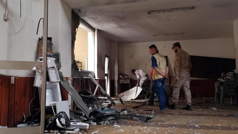 People inspect the damage inside a mosque following a twin bombing in Benghazi, Libya February 9, 2018. REUTERS