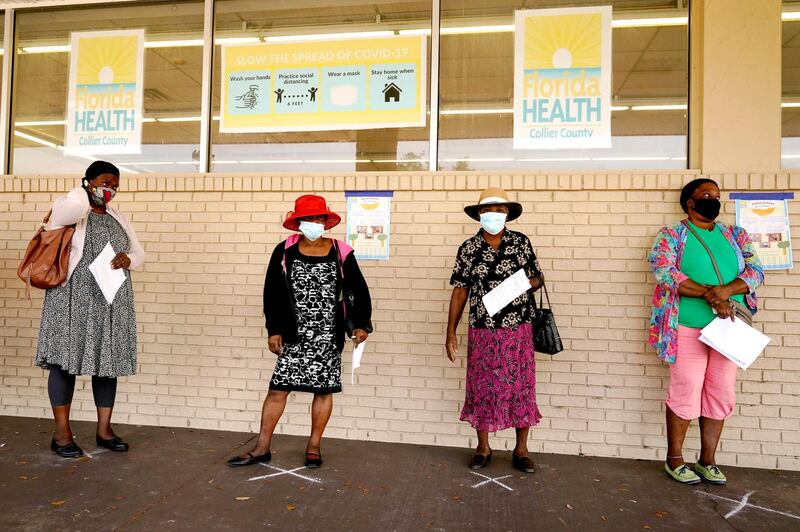 People wait in line to receive the Johnson & Johnson vaccine at a clinic run by Healthcare Network in Immokalee, Florida. AP Photo