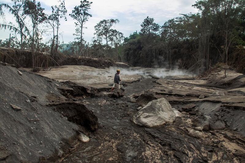 A man walks next to a river in the aftermath of the eruption of Mount Semeru in Lumajang, East Java, Indonesia.  EPA