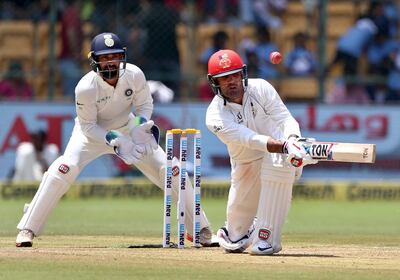 Afghanistan's Mohammad Nabi, right, plays a shot during the second day of their one-off cricket test match against India in Bangalore, India, Friday, June 15, 2018. (AP Photo/Aijaz Rahi)