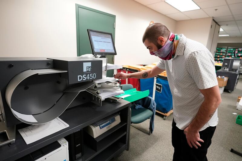 Lehigh County worker uses a scanner to count ballots. AP
