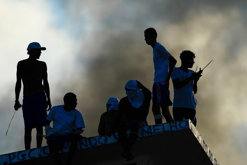 Inmates set fire to a prison wing on January 19, 2017 during a clash between gangs as fresh fighting erupted at Alcacuz Penitentiary Centre near Natal in Rio Grande do Norte, Brazil. Stick-wielding inmates hurled stones and lit fires Thursday in the jail where dozens were previously massacred, as authorities struggled to contain a spreading wave of gang violence. Andressa Anholete / Agence France-Presse