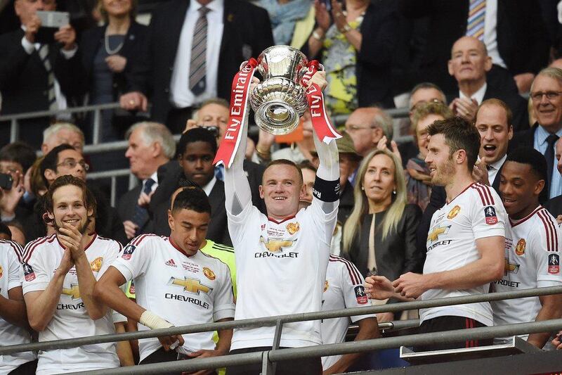 Manchester United’s Wayne Rooney (C) lifts the trophy as he and his teammates celebrate after winning the English FA Cup final between Crystal Palace and Manchester United at Wembley in London, Britain, 21 May 2016. Andy Rain / EPA