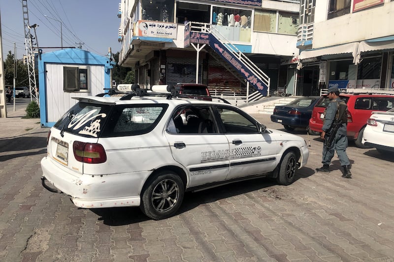 Security officials inspect the scene of an attack on Dawa Khan Menapal, the head of the Afghan government's information centre, in Kabul on August 6, 2021. Taliban militants shot him dead. EPA