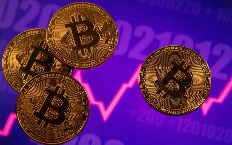 A representation of virtual currency Bitcoin is seen in front of a stock graph in this illustration taken March 15, 2021. REUTERS/Dado Ruvic/Illustration
