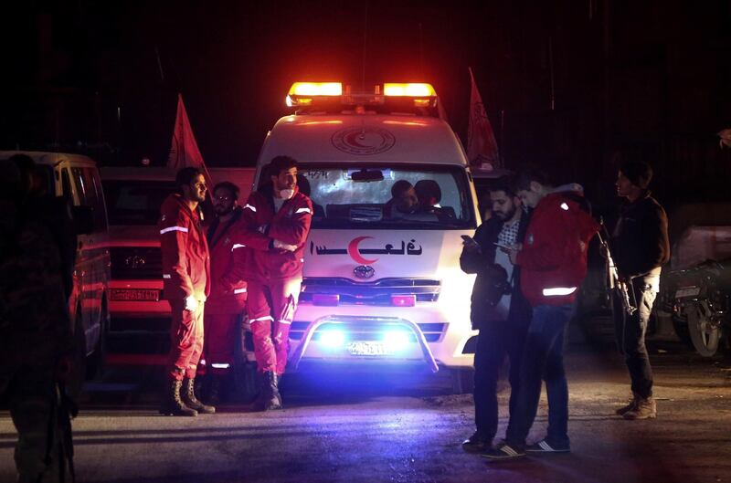 Syrian staff from the International Committee of the Red Cross take part in a medical evacuation operation in Douma in the eastern Ghouta region on the outskirts of the capital Damascus. Amer Almohibany / AFP Photo