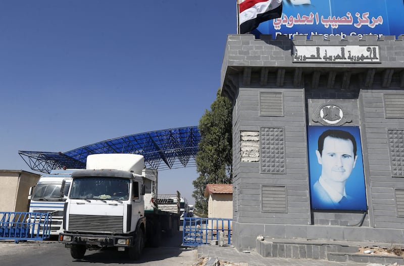 Trucks enter Syria through the Nassib/Jaber border post with Jordan on the day of its reopening, on September 29, 2021, after two months of closure due to fighting in southern Syria. AP